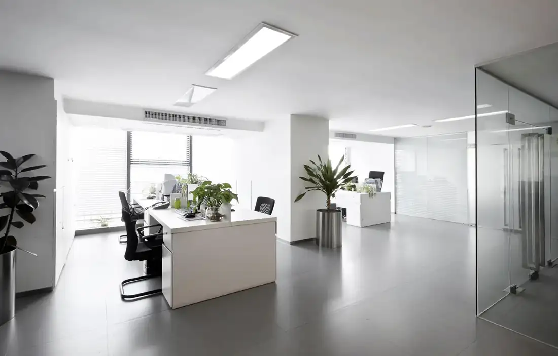Clean, modern office space with daylight through a large window